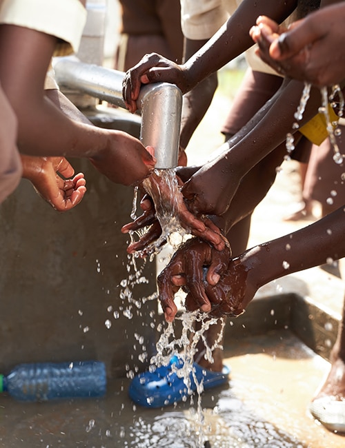 People cleaning their hands with water